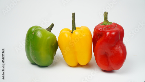 Sweet pepper, green, yellow, red paprika on white background