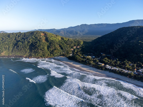 Small island between two beaches with green waters Camburi