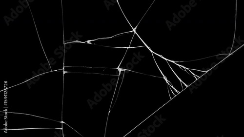 Glass breaking into pieces. Realistic Glass impact crack with detailed fractures on a black background. For overlay, simulating broken glass effects.