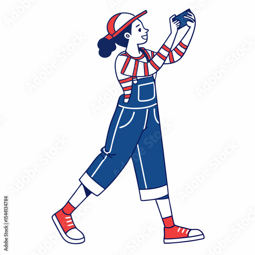 Happy young woman taking photo with smartphone stylish overalls