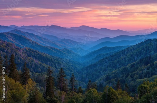 Smoky Mountains at dawn layers of blue ridges fading to pink sky over lush forests