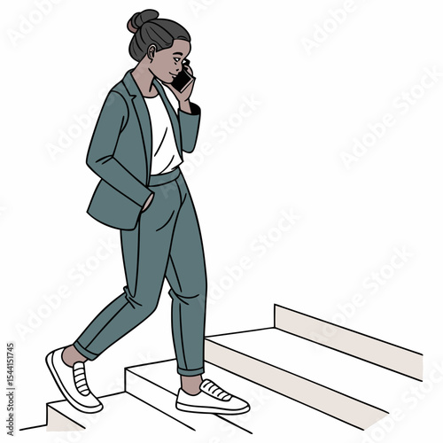 Woman in suit walking upstairs phone call