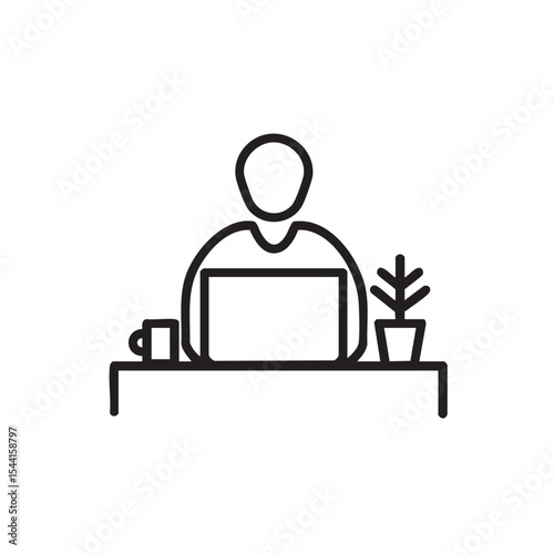 Home office setup with a person working on a laptop at a desk