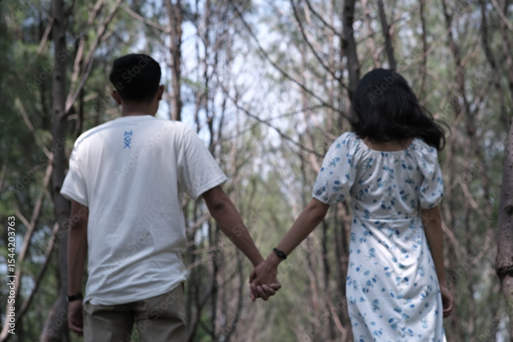young couple walking in park young couple walking in park
