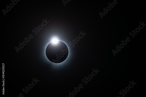 Solar eclipse, totality just starting looking like a diamond ring, solar flares and corona visible
