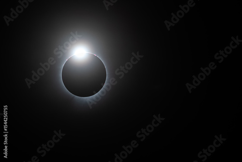 Solar eclipse, totality just starting looking like a diamond ring, solar flares and corona visible
