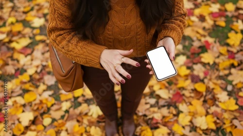 Woman Using Smartphone Amidst Fall Foliage