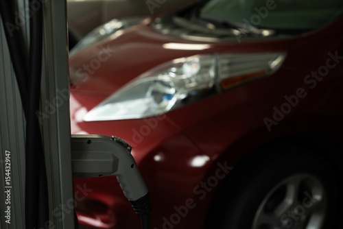 Charging plug hanging at charging station