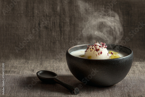 a bowl of food with a spoon and spoon rest on a table