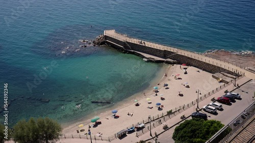 Aerial view of tourists enjoying summer vacations on the beach in Pizzo Calabro, a charming town on the Tyrrhenian coast of Southern Italy