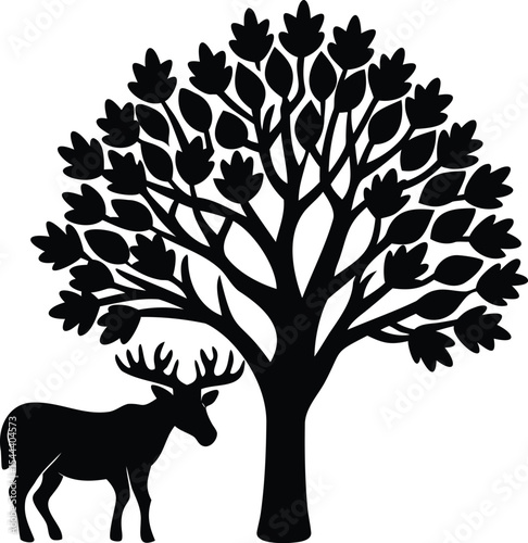 Black silhouette of a deer standing next to a tree with leaves