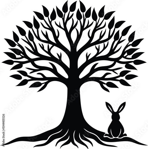 Silhouette of a leafy tree and a rabbit sitting under it