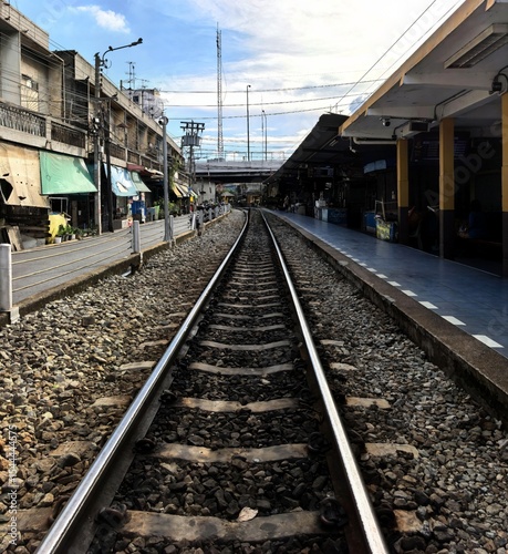 Empty railway tracks leading to an urban train station