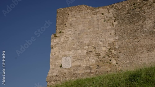 Majestic Norman Castle wall standing tall against a vibrant blue sky in Vibo Valentia, Calabria, Southern Italy
