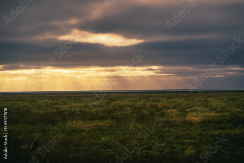 Countryside view with sun light ray with cloudy with grass field in iceland.