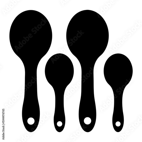 Four different sized black measuring spoons arranged on a white background