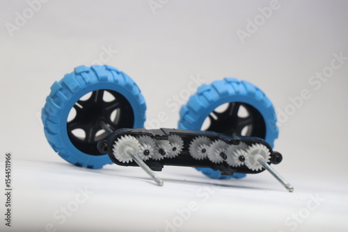 Inside view of gears from a small remote car. Plastic gears connected to wheels with the shaft a detailed view