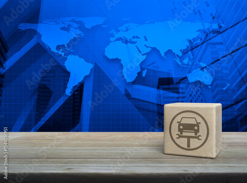Fototapeta Naklejka Na Ścianę i Meble -  Service fix car with wrench tool icon block cube on wooden table over world map, city tower and skyscraper, Business repair car service concept, Elements of this image furnished by NASA