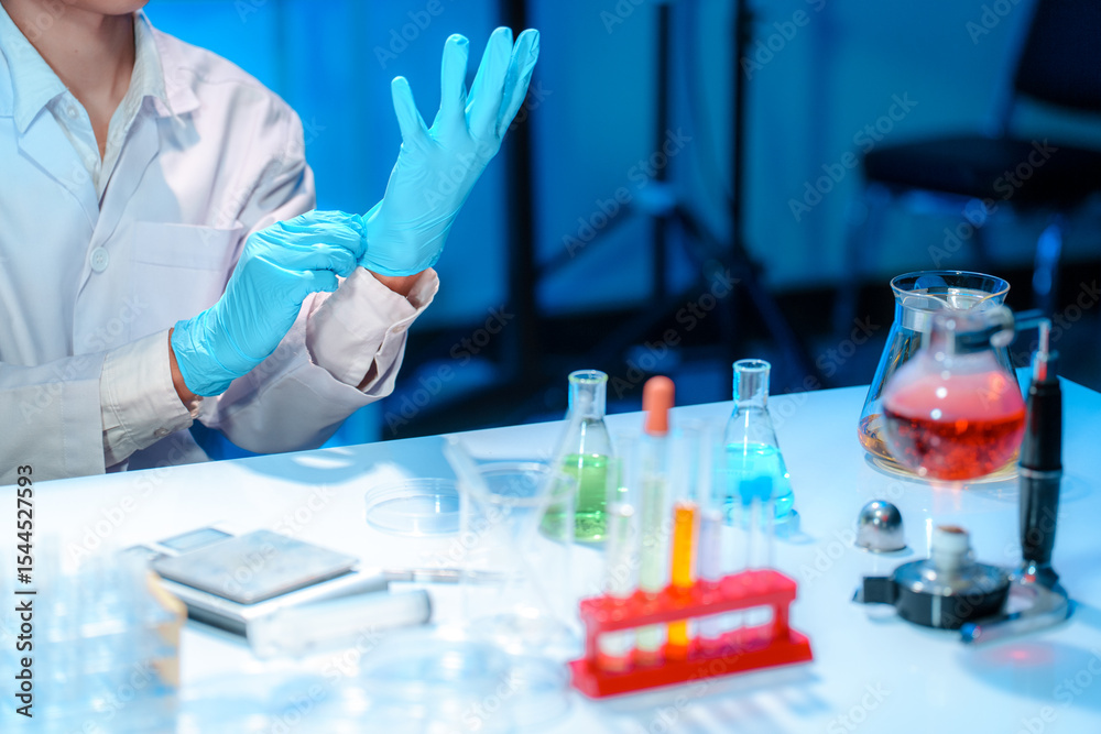 Fototapeta premium Laboratory Scientist Preparing for Experiment with Protective Gloves