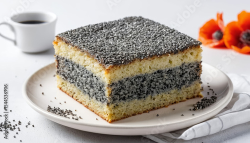 A slice of poppy seed cake on a white plate, topped with powdered sugar. AI generated.
