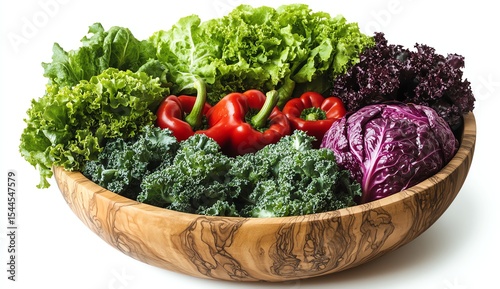 Fresh greens and peppers in a wooden bowl on a white background.
