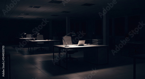 Quiet and dark office interior at night, featuring empty desks illuminated by soft lamps. A serene scene depicting solitude, late work, or stillness after business hours.