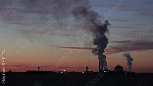 Multiple Industrial Smokestacks at Sunset, Factory Emissions Against Colorful Sky