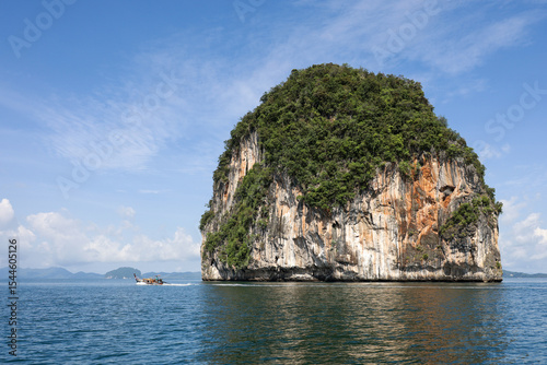 Rock island covered with tropical forest in Andaman sea, Krabi Province in Thailand. Background for travel on paradise nature