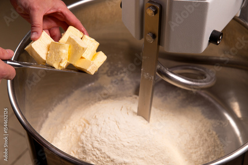 Put butter in a dough mixer.