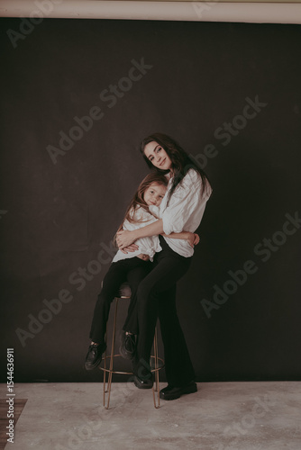 mother and daughter posing in studio, family photo