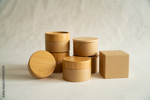 Stacked EcoFriendly Cardboard and Bamboo Packaging for Cosmetics on White Background Product Shot