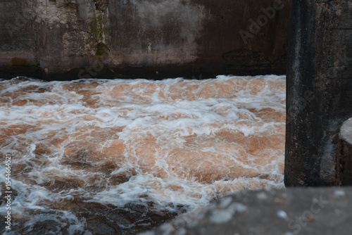 Dam of small hydroelectric power station, water discharge through locks