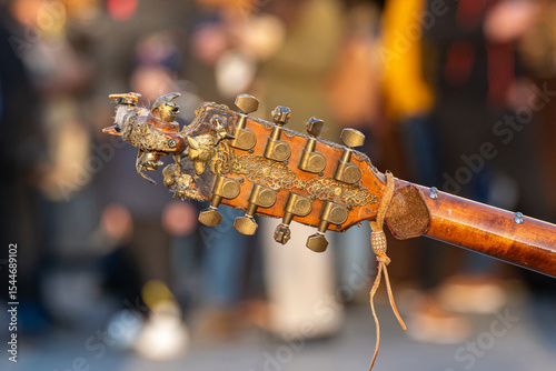 detail of the neck of a handmade mandolin, background for concept of string musical instruments