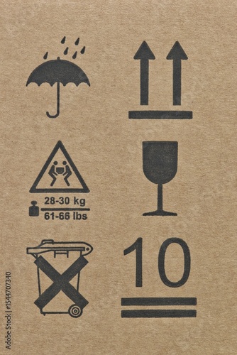 Warning labels packaging symbols silhouette shapes umbrella glass arrows this way up fragile keep dry height limit two person carry transportation logistics instructions.