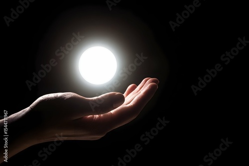 A hand cradles a glowing gift, like holding a tiny sun in the darkness.