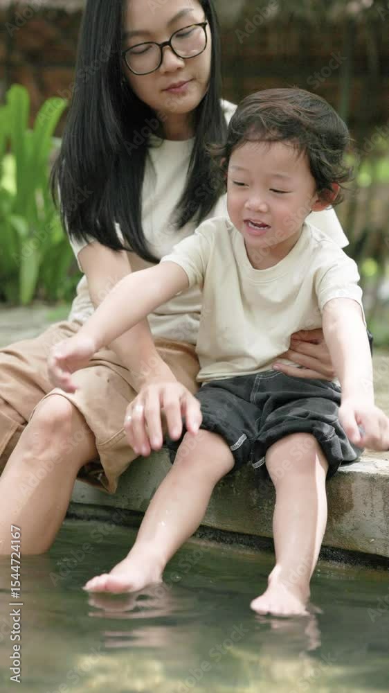 Mother and child enjoy a peaceful foot soak in a hot spring at Sankampaeng, Chiang Mai. A heartwarming moment of bonding, learning, and calm connection in nature. Mother and child enjoy a peaceful foot soak in a hot spring at Sankampaeng, Chiang Mai. A heartwarming moment of bonding, learning, and calm connection in nature.