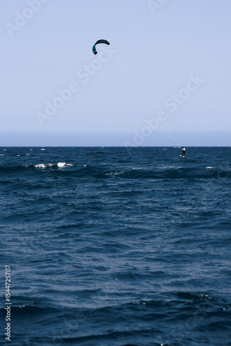 Canvas Print Kitesurfer surfing the waves in Rosas, Costa Brava, Spain