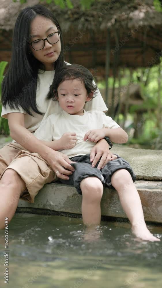 Mother and child enjoy a peaceful foot soak in a hot spring at Sankampaeng, Chiang Mai. A heartwarming moment of bonding, learning, and calm connection in nature. Mother and child enjoy a peaceful foot soak in a hot spring at Sankampaeng, Chiang Mai. A heartwarming moment of bonding, learning, and calm connection in nature.