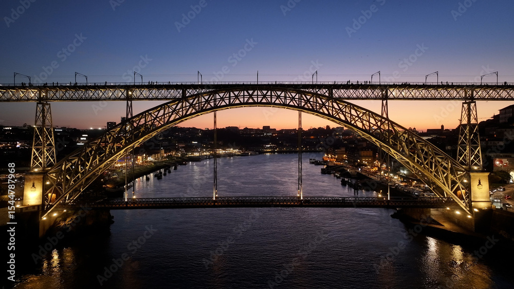 Obraz premium Sunset Dom Luis I Bridge At Porto In District Of Porto Portugal. Sunset Skyline Scene. Illuminated Bridge Landscape. Dom Luis I Bridge At District Of Porto Portugal. Railroad Transport. 