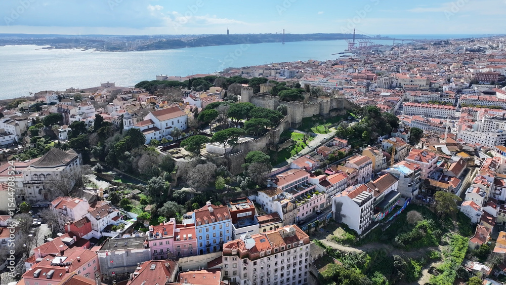 Fototapeta premium Sao Jorge Castle At Lisbon In Lisbon District Portugal. Medieval Castle Scenery. Ancient Cityscape. Sao Jorge Castle At Lisbon In Portugal. Historical City Landscape. Tourism Travel Destination.