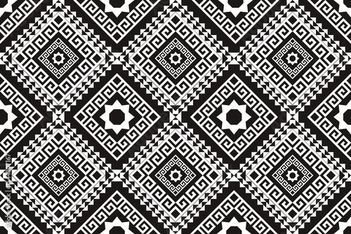 A bold black and white seamless pattern inspired by traditional geometric and ethnic motifs. Featuring sharp diamond shapes, spiral elements, and symmetrical pixel details, this design is ideal for in