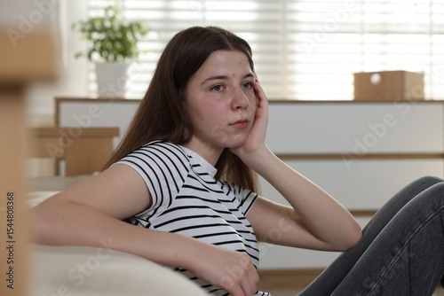 Upset teenage girl on floor at home Free Download Upset teenage girl on floor at home - GFXLoad