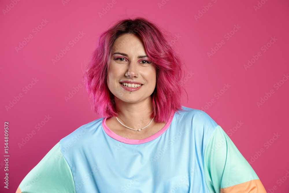 Fototapeta premium Beautiful woman with bright dyed hair on pink background