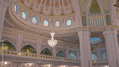 The mosque is decorated with golden patterns. The mosque is decorated with colorful mosaics. Under the dome of the mosque is a colorful golden chandelier for lighting.