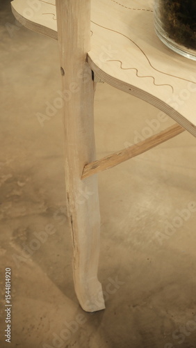 This photo features cup, dining table and vase set in a architecture environment.