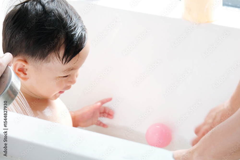 The little child is taking a bath in the bathtub. The little child is taking a bath in the bathtub.