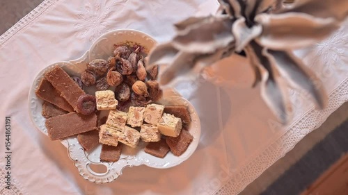 Traditional Croatian Dessert Plate with Figs, Almond Nougat and Sweets on White Lace Tablecloth