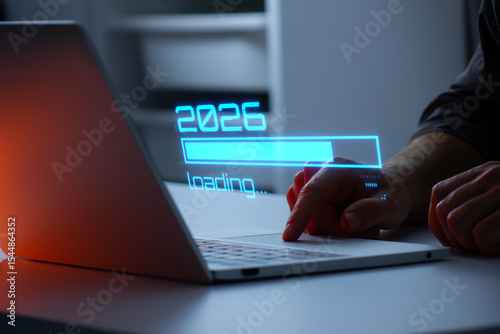 Man interacting with a holographic 2026 loading bar in blue color. Concept of new year, annual plan, growth strategy, business planning, investment trends and strategy road map.