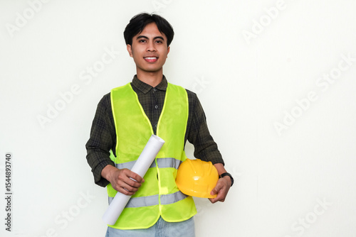 Portrait of a smiling, confident young Asian engineer standing against an isolated background. Ideal for advertisement and professional themes