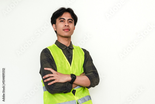 Confident Asian construction worker crossing arms and smiling at the camera on white background. Perfect for industrial, labor, or recruitment advertisement themes